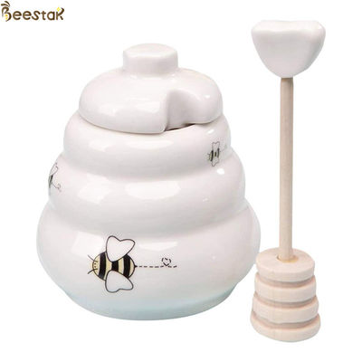 Weißer leerer GroßhandelsHoney Jar Ceramic Honey Pot mit hölzernem Schöpflöffel für Honigspeicher